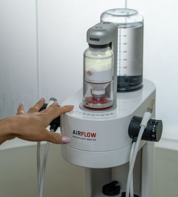 A B Well Dental Studio hygienist using the AIRFLOW Guided Biofilm Therapy handpiece during a cleaning