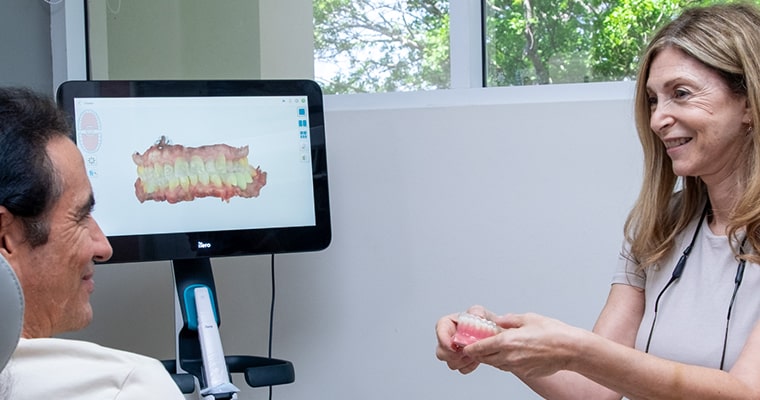 Dr. Leana Thanos reviewing a 3D bite scan with a TMJ patient at B Well Dental Studio in Weston, FL