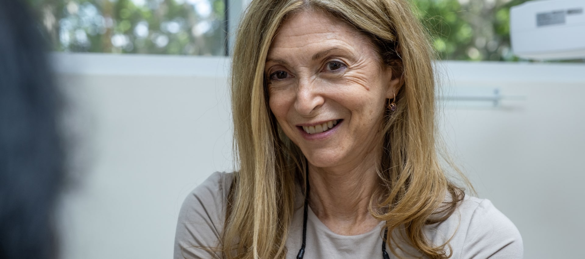 A photo of doctor Thanos smiling while talking with patient