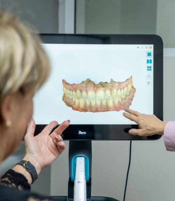 A photo of doctor and patient talking about jaw model