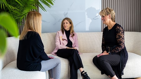 A photo of doctor and patients sitting together and talking
