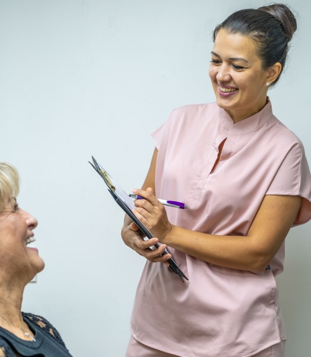 A photo of happily smiling patient while talking with team member