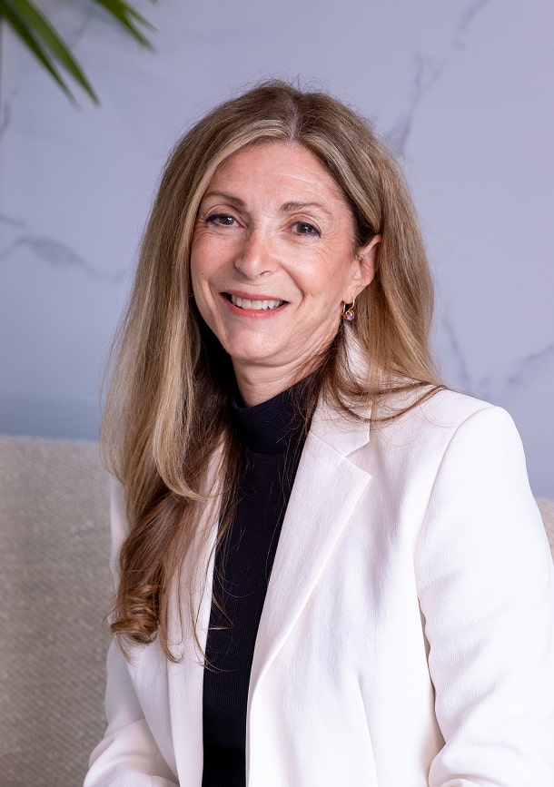 Doctor Thanos smiling while wearing her white coat