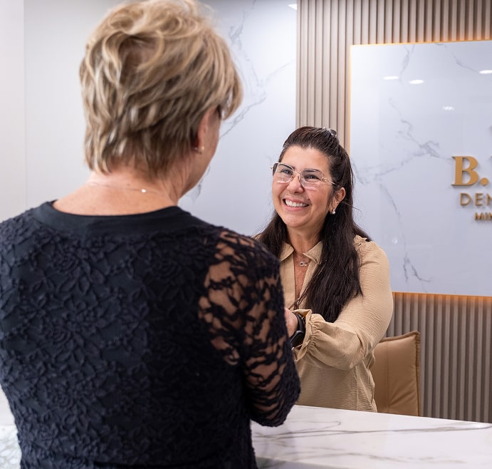 Our team members happily smiling to our patient